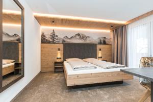 Postel nebo postele na pokoji v ubytování Hotel Garni Pfeifer