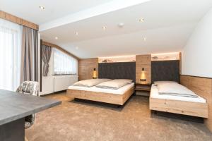 Postel nebo postele na pokoji v ubytování Hotel Garni Pfeifer