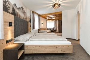 Postel nebo postele na pokoji v ubytování Hotel Garni Pfeifer