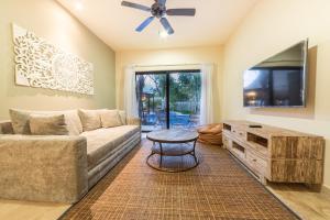 a living room with a couch and a table at Magic Paramar Terra C103 in Aldea Zama Tulum in Tulum +15 photos