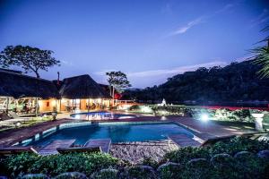 a swimming pool in a resort at night at N'taba River Lodge & Spa in Port St Johns