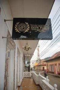 a sign hanging from the side of a building at Hotel Boutique Don Polo in San Juan Nepomuceno