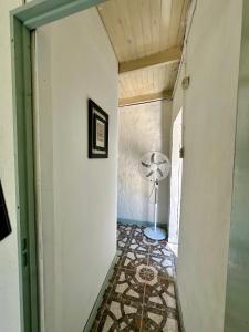 a hallway with a room with a fan on the floor at Casa Río General Belgrano in General Belgrano