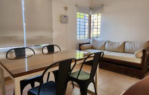 a living room with a couch and a table and chairs at Quadro Departamentos in Villa Carlos Paz