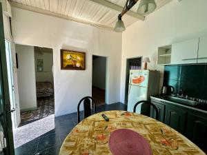 a kitchen with a table and a refrigerator at Casa Río General Belgrano in General Belgrano