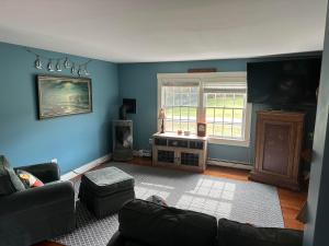 a living room with blue walls and a couch at Sugar Hill Inn in Sugar Hill