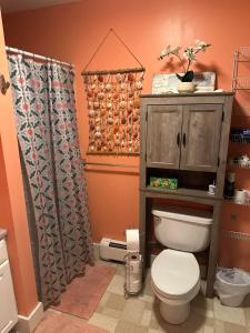 a bathroom with a toilet and a shower curtain at Sugar Hill Inn in Sugar Hill