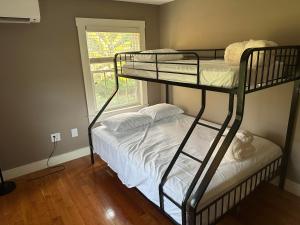 a bedroom with two bunk beds and a window at Sugar Hill Inn in Sugar Hill