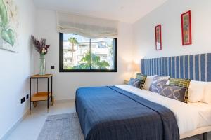a bedroom with a bed and a window at Luxury penthouse with ocean views in Estepona +18 photos