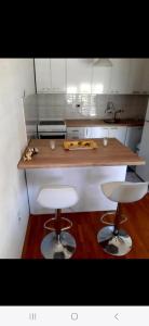 a kitchen with a counter and two bar stools at VN APARTMENTS OHRID in Ohrid +15 photos