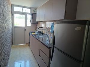 a kitchen with a refrigerator and a counter top at Departamento amplio en zona tranquila cercana al centro de Ezeiza in Ezeiza +9 photos