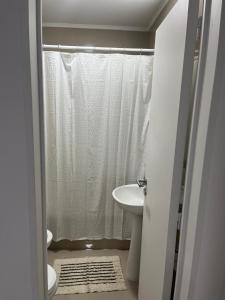 a bathroom with a white shower curtain and a sink at Departamento Rodriguez in Bahía Blanca +20 photos