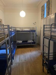 a room with three bunk beds and a light at Dockside Hostel in Stockholm