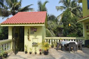 a house with a table and chairs on a patio at Bageecha B&B-Jal in Alibaug +52 photos