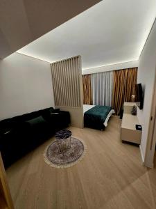 a living room with a bed and a couch at Happy Studio Luxury Cortina North in Voluntari