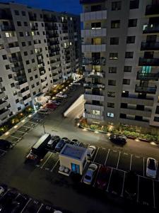 a view of a parking lot in a city at night at Happy Studio Luxury Cortina North in Voluntari