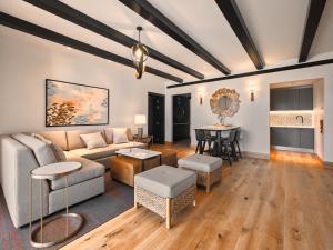 a living room with a couch and a table at Viceroy Residences at Ombria Algarve in Loulé