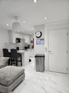 a room with a kitchen and a living room with a door at Luxury and stylish 3 bedroom house or Apartment in Greenhithe - Available for booking as individual Room or as a Whole apartment - 11mins walk to Greenhithe Train Station, 7 mins drive to Bluewater shopping mall in Greenhithe +52 photos