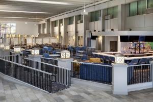 a lobby with chairs and tables in a building at Holiday Inn Sioux Falls-City Center by IHG in Sioux Falls