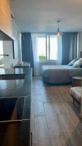 a bedroom with a bed and a desk with a sink at Roca Town House in Viña del Mar