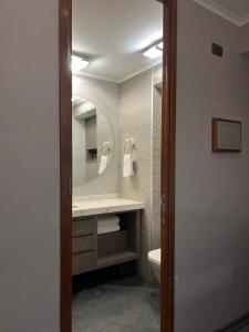 a bathroom with a sink and a mirror at Roca Town House in Viña del Mar +28 photos