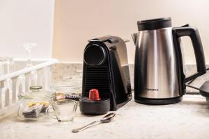 a kitchen counter with a coffee maker and a tea kettle at The Majestic Marrakesh Studio Cairo's Downtown 19A in Cairo