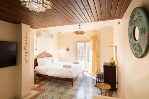 a bedroom with a white bed and a television at The Majestic Marrakesh Studio Cairo's Downtown 19A in Cairo