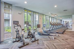 a gym with a row of treadmills and exercise bikes at Attractive 2BD 2BA w Beautiful Pool in Fort Worth in Fort Worth