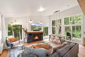 a living room with a couch and a fireplace at Chalet La Colline in Labelle