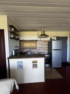 a kitchen with a white refrigerator and a stove at Casa FLORIDA in Villa Serrana