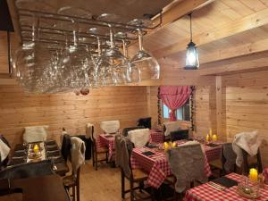 a restaurant with tables and chairs and a chandelier at Nash Pratik Hotel in Geneva