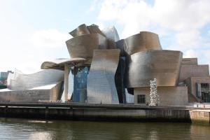 a building with a christmas tree in front of it at Santana Apartment Metro in Las Arenas