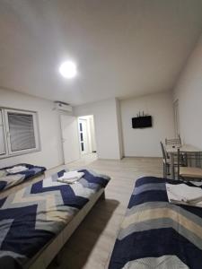 a room with two beds and a table in it at Sky Center Apartments in Ohrid
