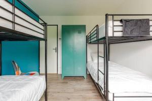 ChassironLa maison du Bout du Monde, Jacuzzi, Climatisation, 4 chambres, Plage à 600M et Phare à 1Km的带两张双层床和蓝色门的房间