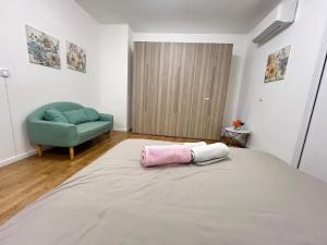 a bedroom with a bed with a pink pillow on it at Lena Apartment Your Venice Gateway in Mestre in Mestre