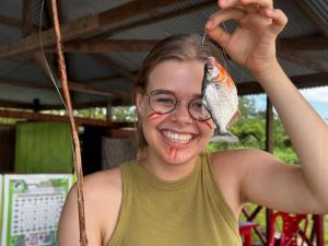 a young girl with a fish on her face at Estación Biológica Santa María de Fátima II Zona in Iquitos