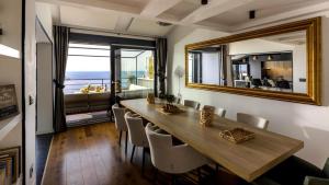 a dining room with a table and a mirror at Shanti Dubrovnik in Dubrovnik