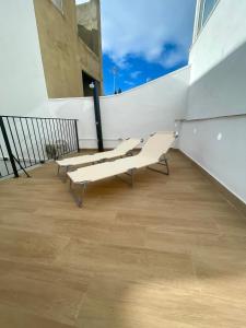 a group of benches sitting on a balcony at Dream Big with jacuzzi and terrace in Ruzafa in Valencia