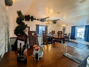 a dining room with a wooden table and a dining room at The Mill House Hotel in Buckie