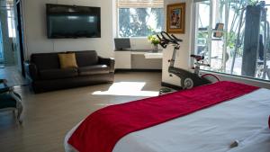 a bedroom with a bed and a living room with a couch at Un lugar ideal para la Feria de Cali in Cali