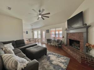 a living room with a couch and a fireplace at Pecan Place Rustic Charm Temple Texas in Temple