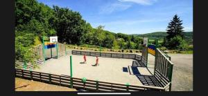 a basketball court with people standing on a court at Chalet climatisé dans un écrin de verdure in Lissac-sur-Couze +8 photos