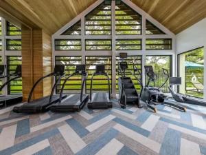 a gym with treadmills and elliptical machines at Pampering New Unit Studio 1Ba Pool, Golf Sim in Austin