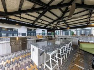 an open kitchen with a large table and chairs at Pampering New Unit Studio 1Ba Pool, Golf Sim in Austin