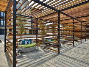 a pergola with a couch and chairs on a patio at Pampering New Unit Studio 1Ba Pool, Golf Sim in Austin
