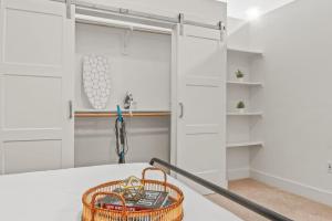 a white garage with a door and a basket at Pampering New Unit Studio 1Ba Pool, Golf Sim in Austin