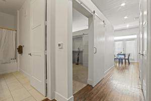 a hallway with a table and a glass door at Pampering New Unit Studio 1Ba Pool, Golf Sim in Austin