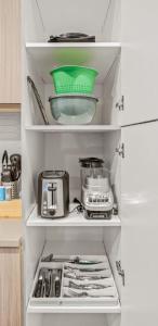 a refrigerator filled with lots of kitchen items at Pampering New Unit Studio 1Ba Pool, Golf Sim in Austin