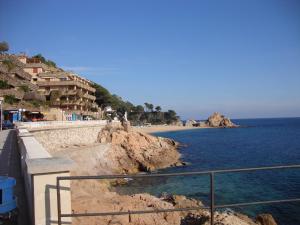a view of a beach with buildings and the ocean at Apartaments Claudi in Tossa de Mar