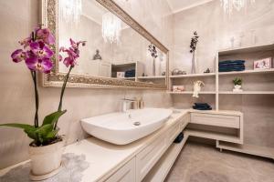 a bathroom with a sink and a mirror at Basilica view prime apartment with free parking in Budapest +36 photos